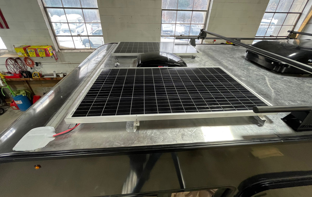 The finished panels are strong and out of the way of anything on the roof, and the roof rack is still usable. The cables have been tied together and routed down to the charge controller.