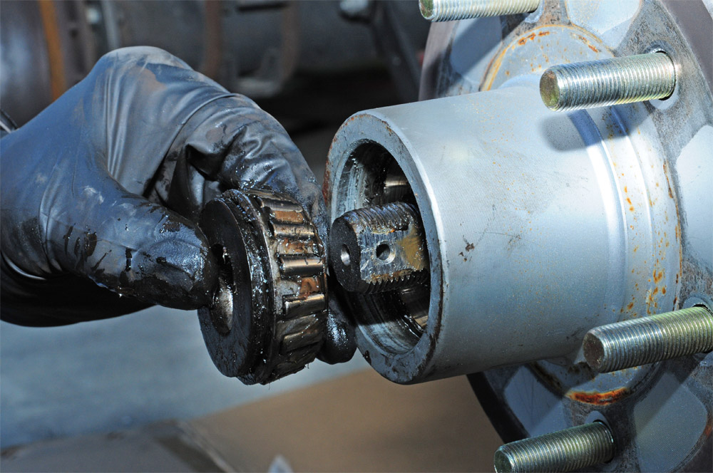 mechanic carefully removes outer bearing carefully