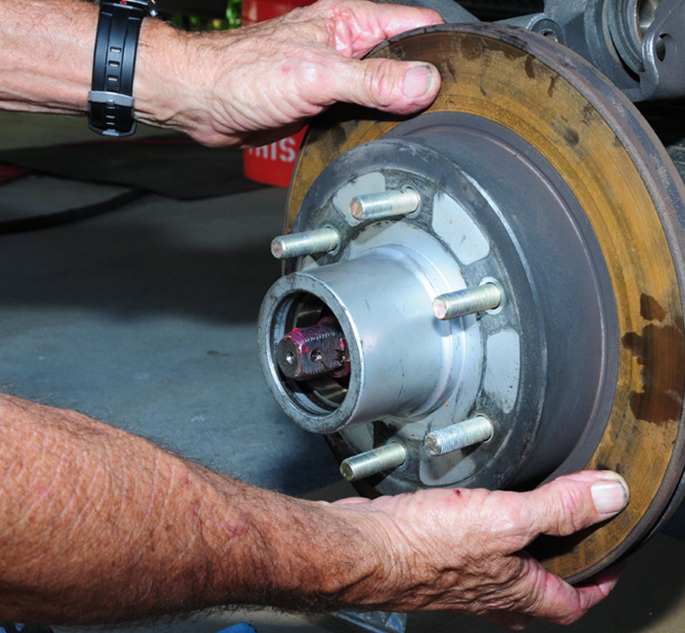 mechanic carefully re-installs rotor
