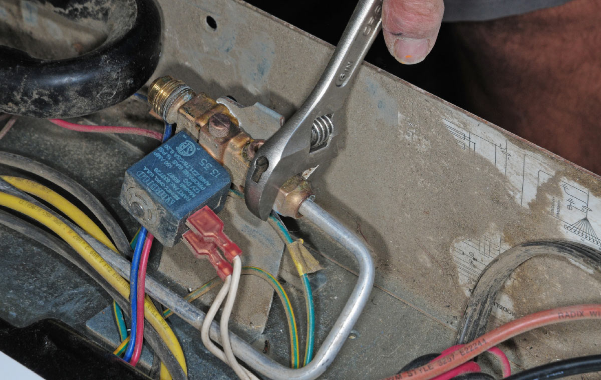 Disconnect the line from gas valve and set aside