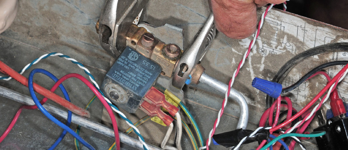 Using a back-up wrench, tighten