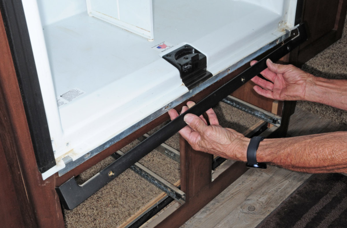 pulling fridge from the cabinet