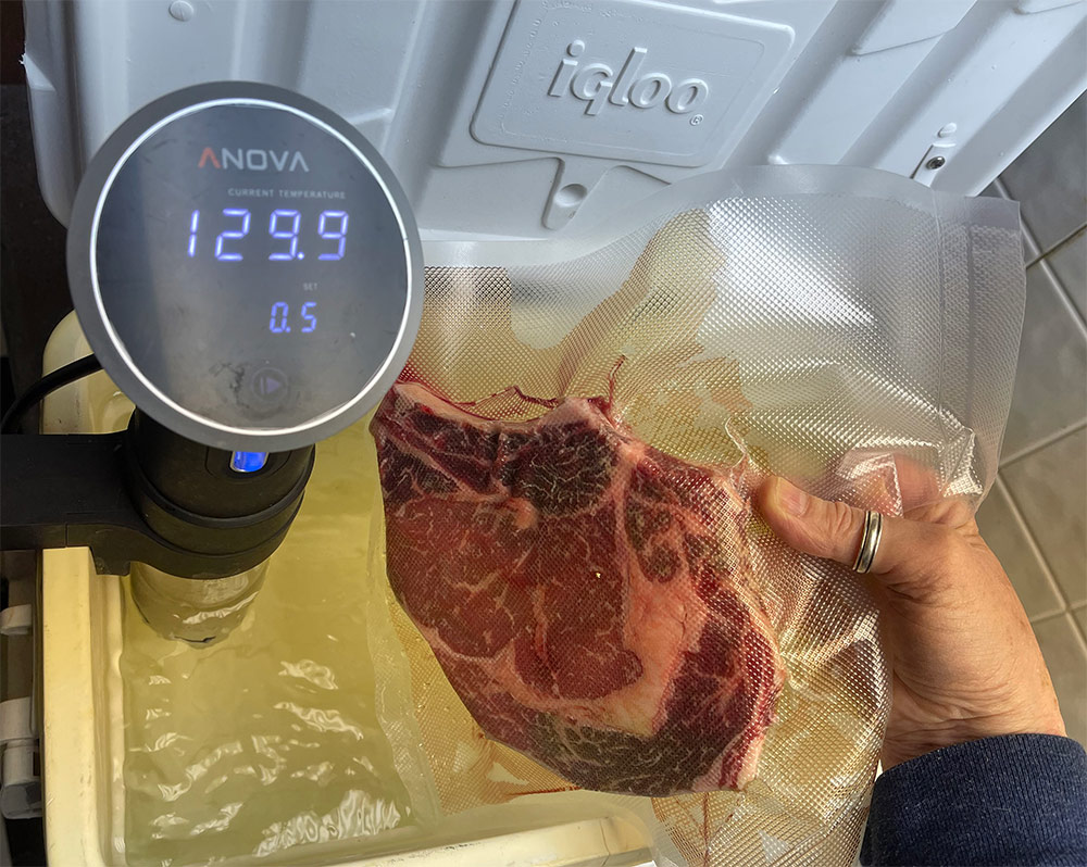 A sealed rib eye going into the sous vide bath.