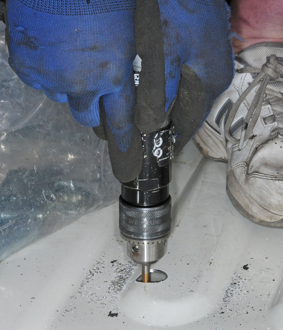 Lining up the holes through the truck bed and rear brackets is not an exact science. Here, a larger drill bit was used to shave enough metal to line up the bolt holes.