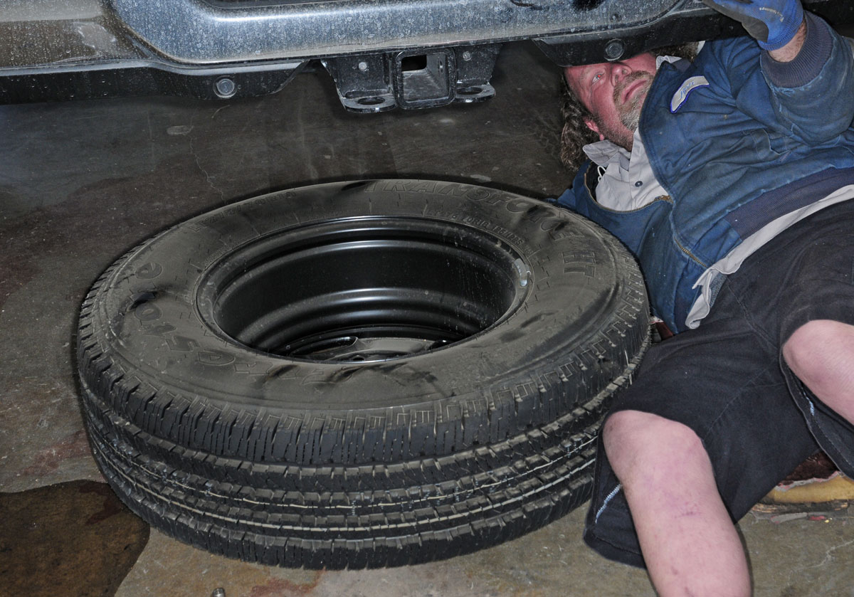 Before crawling under the truck to install the brackets, the spare tire and metal shield will have to be removed to provide access to the frame
