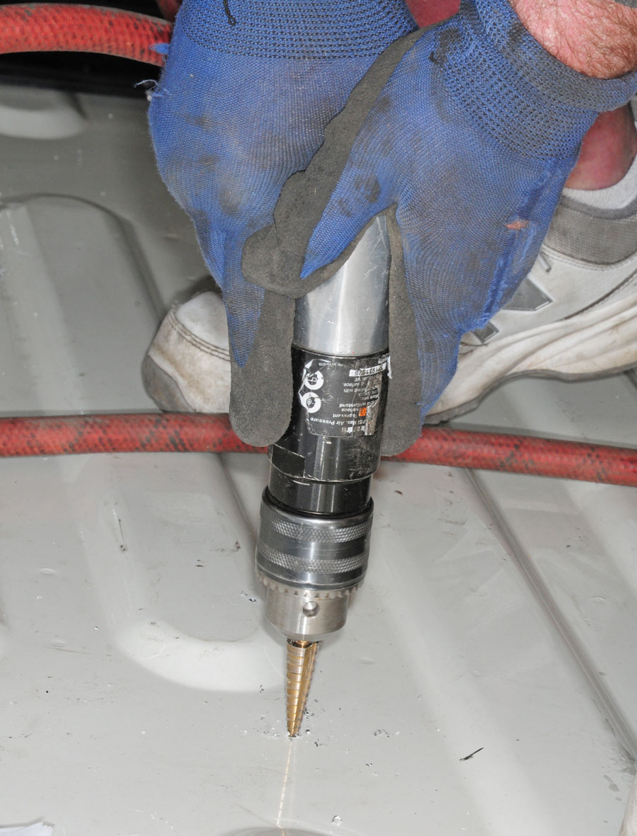 A step bit is used to drill the bolt holes through the bed, which is recommended by PullRite