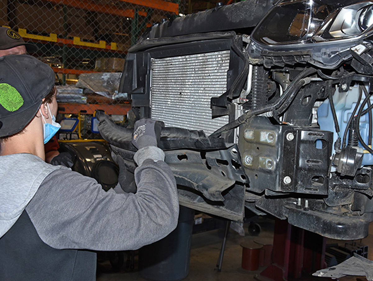 mechanic removes inner bumper structure