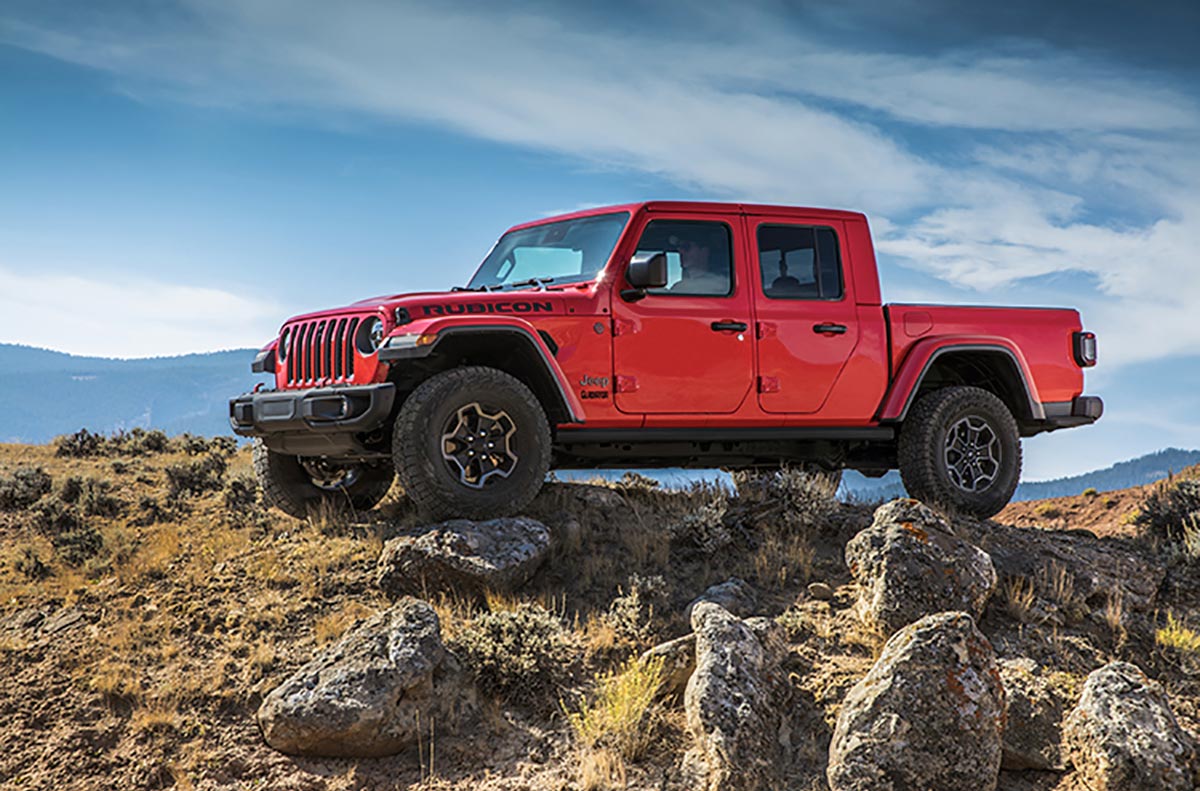 A red Jeep Gladiator side profile view