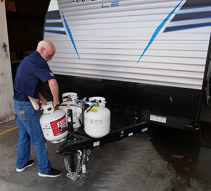 Technician Eddie Blevins performing a drop test of a travel trailer’s LP-gas system