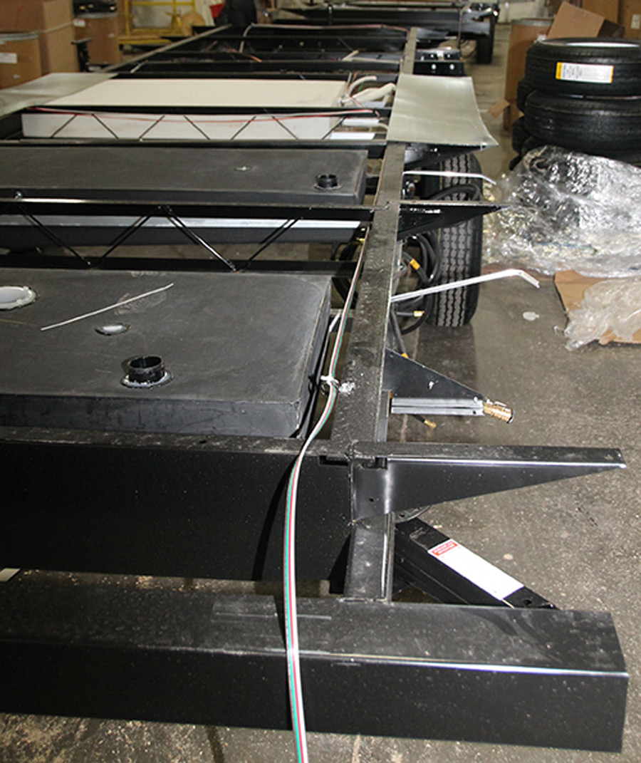 Grey- and black-water tanks are installed in this travel trailer along with the (white) freshwater tank