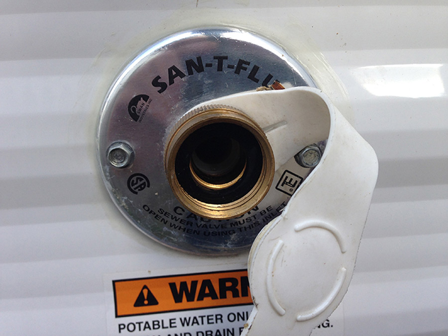 The black tank flush (if equipped) will have a separate garden hose connection from the city water connection (shown here)