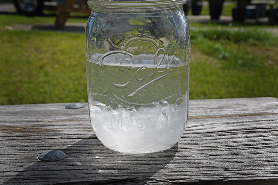 toilet paper in water in a mason jar