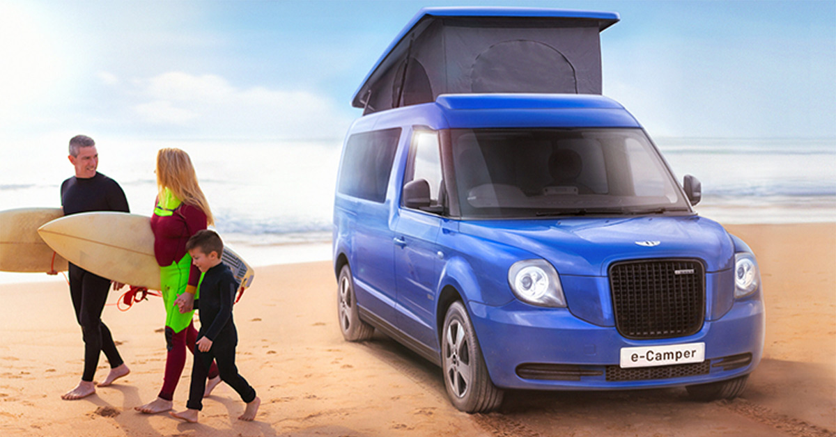 Family on the beach next to blue electric RV