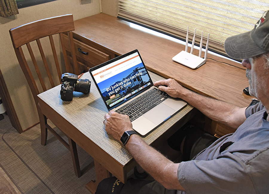 man on his laptop on the RV Enthusiast website