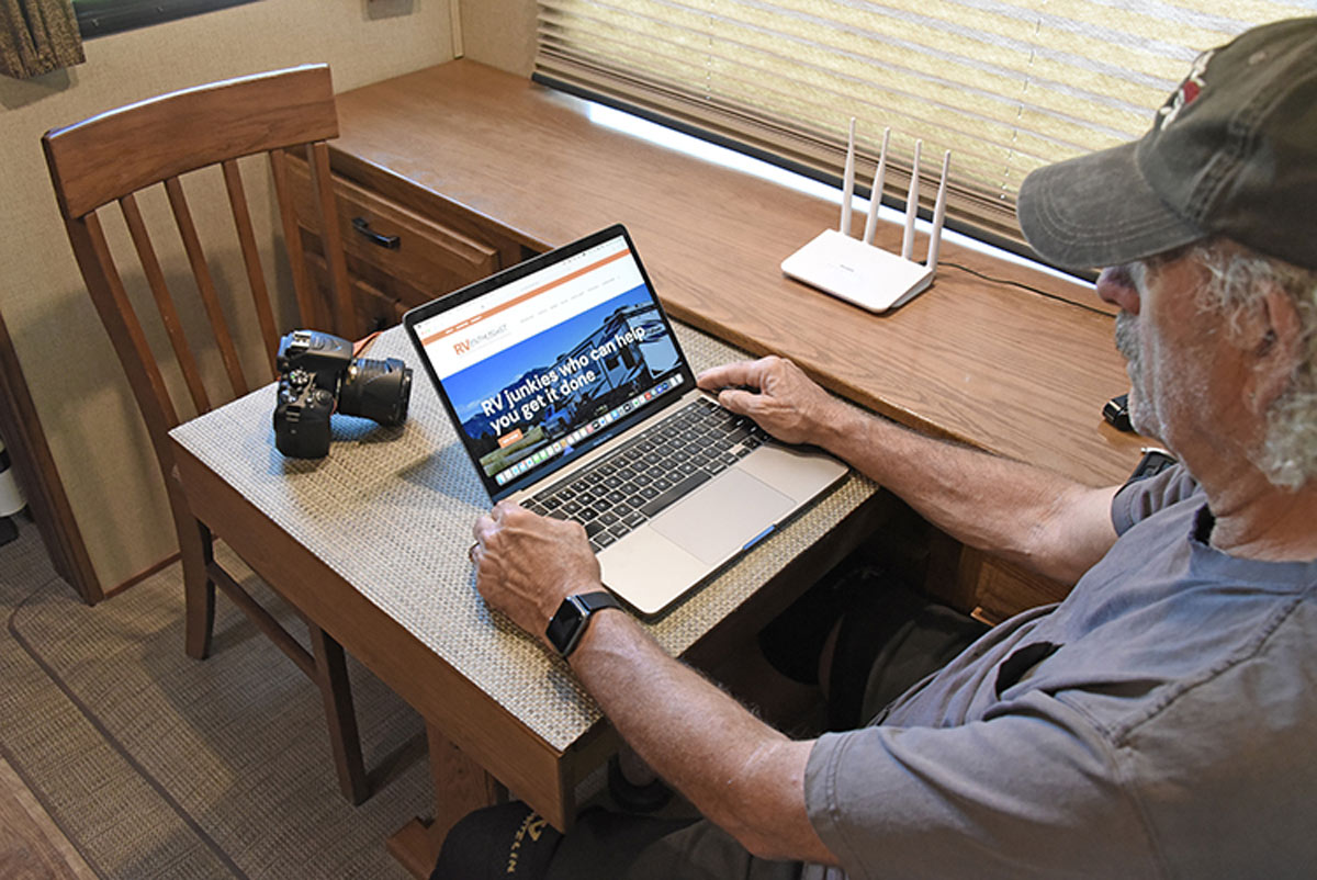 man on his laptop on the RV Enthusiast website