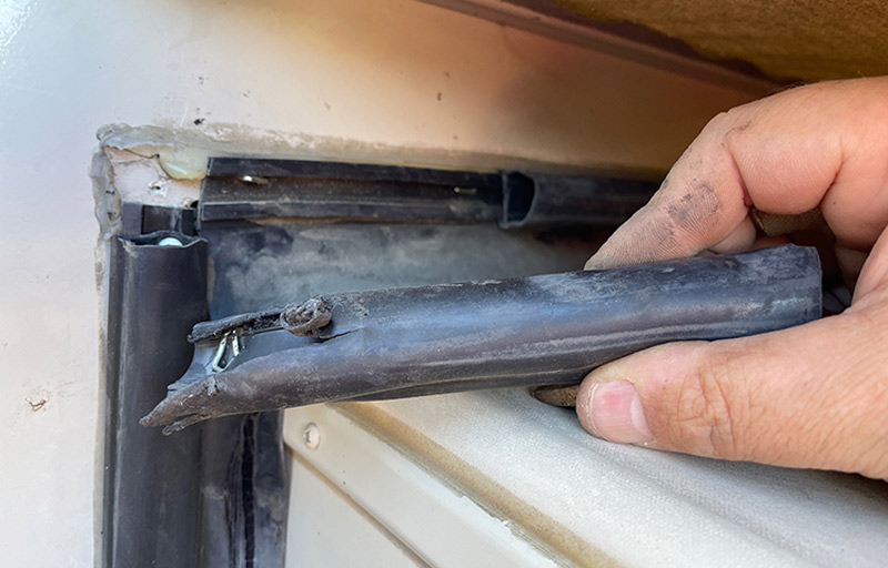 A section of damaged bulb seal was cut under the slide-out topper and removed from the H-track. This required removing staples that held the H-track in place.
