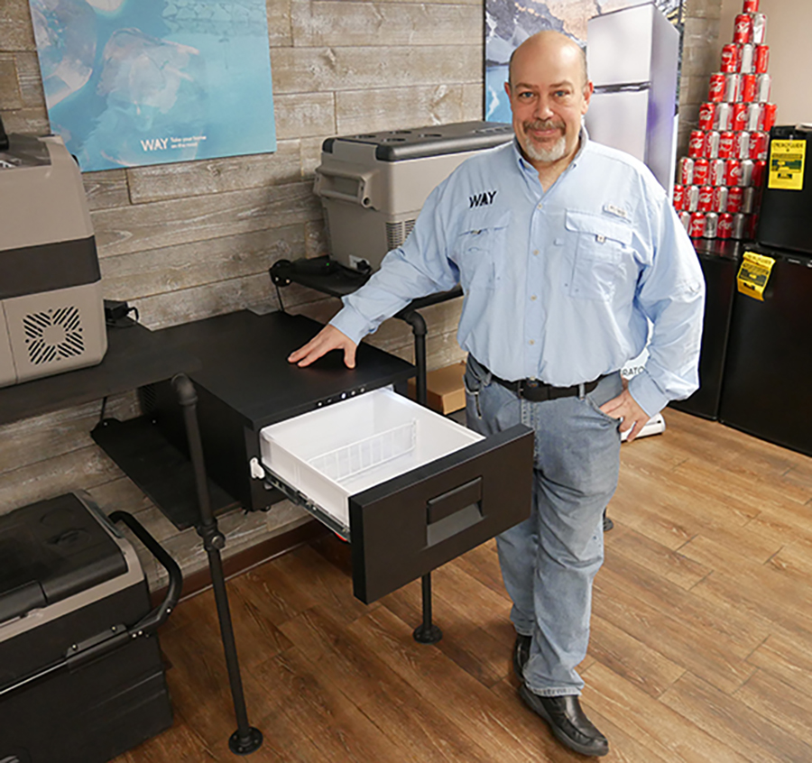 Chris Greer with the company’s lineup of portable refrigerators