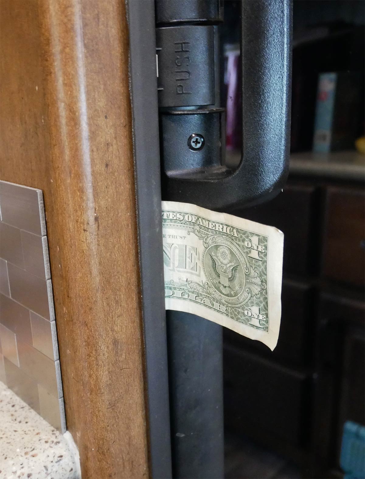 Dollar bill inside a fridge door