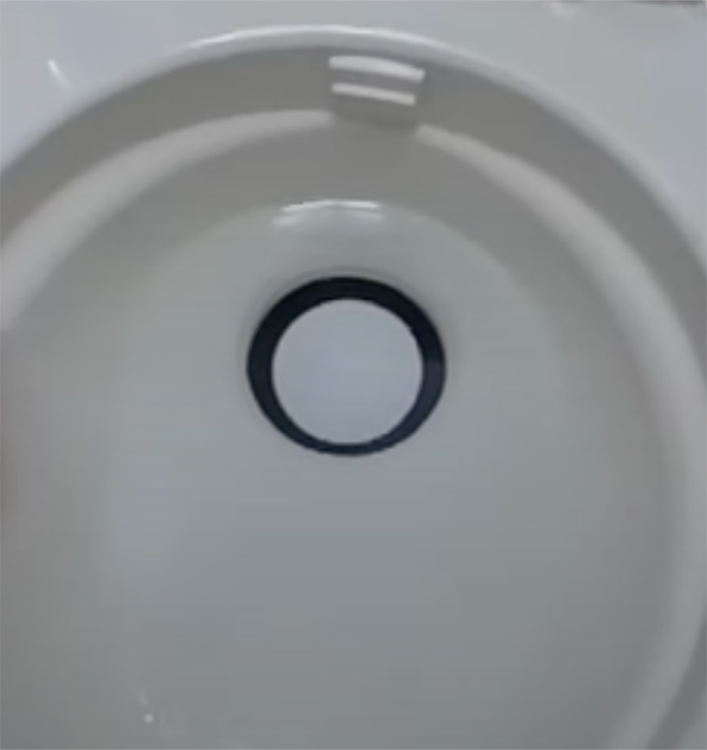 Closeup of a toilet bowl hole