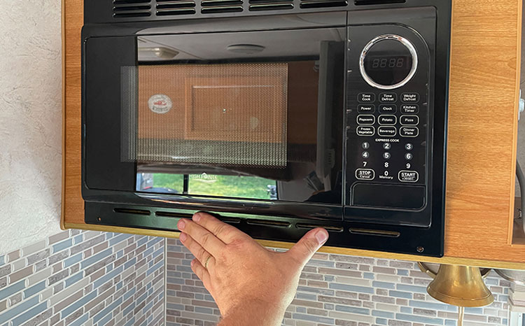 We confirmed the fit and screwed the face into the cabinet, after running the power cord into the adjacent cabinet to plug it in