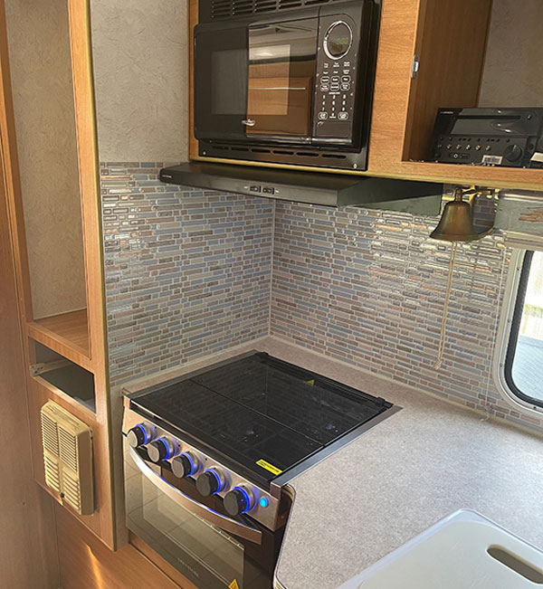 The new appliances go a long way to modernizing the interior appearance of our 16-year-old truck camper — and their performance will definitely bump our galley skills up a notch