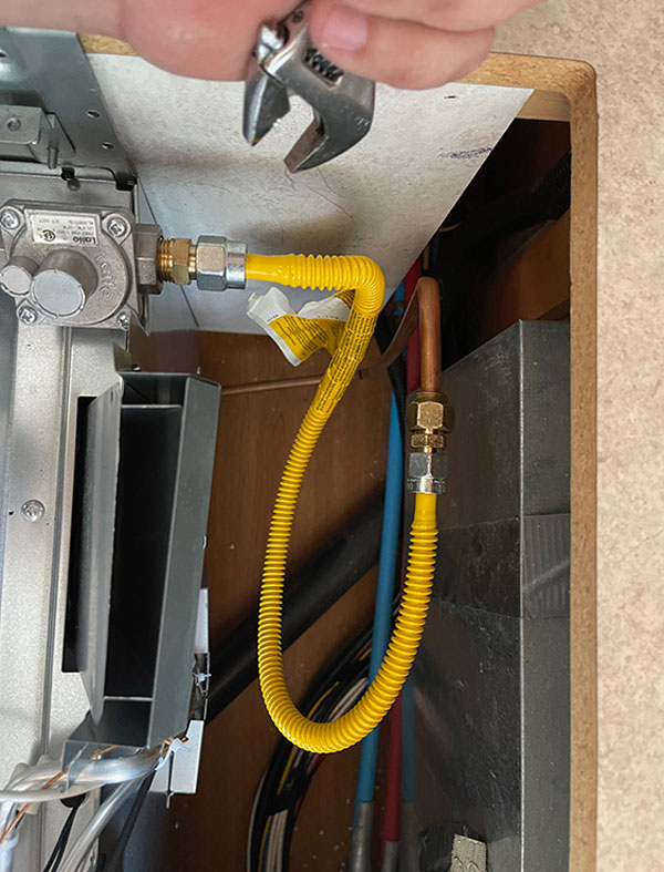 The gas line installed and the range screwed down and reassembled, we tested the LP-gas connections for leaks