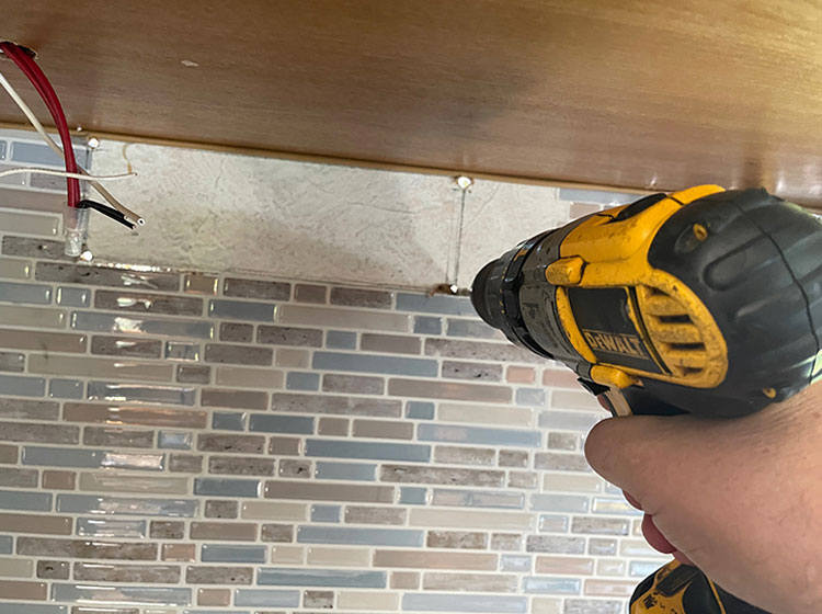 For this install, we upgraded the range hood from a recirculating model to an outside vent