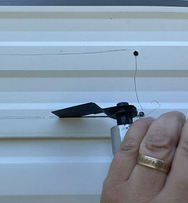 We used an oscillating cutter to make our cuts, starting with the aluminum siding and working inward to check each level