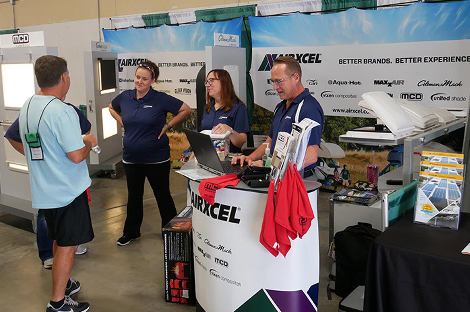 attendees visit an Airxcel supplier booth