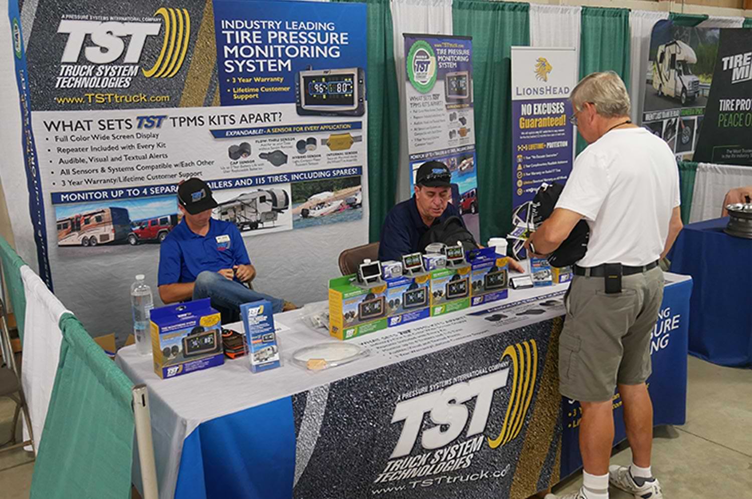 attendees visit a Truck System Technologies supplier booth