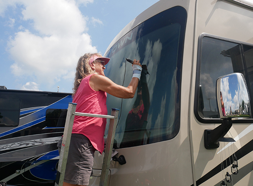 Karen Rambow, owner of Rambow’s Glass Repair, works her magic on an RV windshield