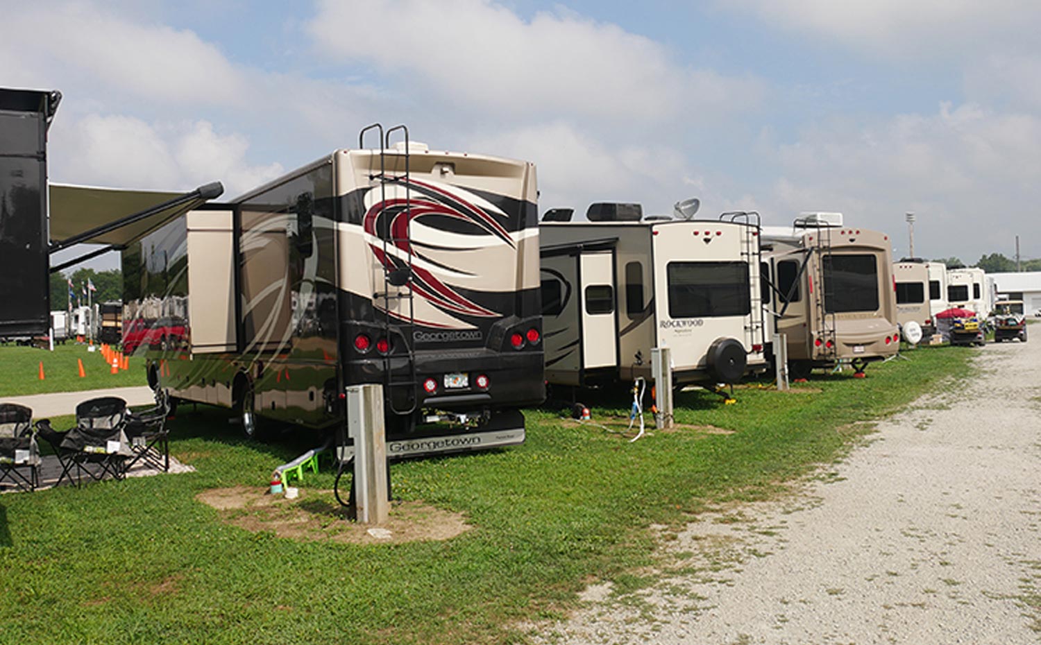 a line of RV with nameplates from various states