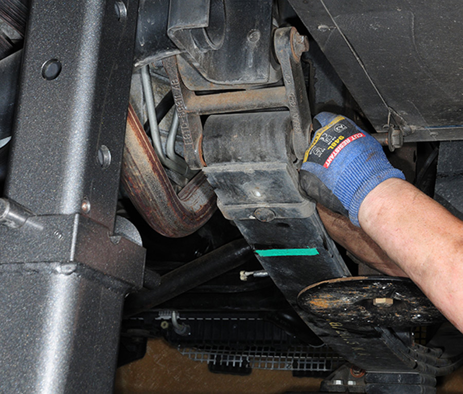 Leaf springs, shocks and factory hardware are stripped from the frame up front to get ready for installing the LiquidSpring components