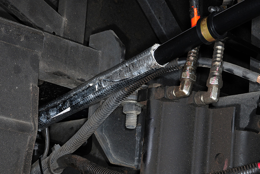 Any hose that passes through an area that may cause abrasion is wrapped with a protective conduit