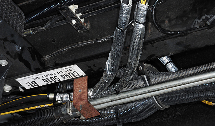 Heat-resistant conduit was placed around any hydraulic hose