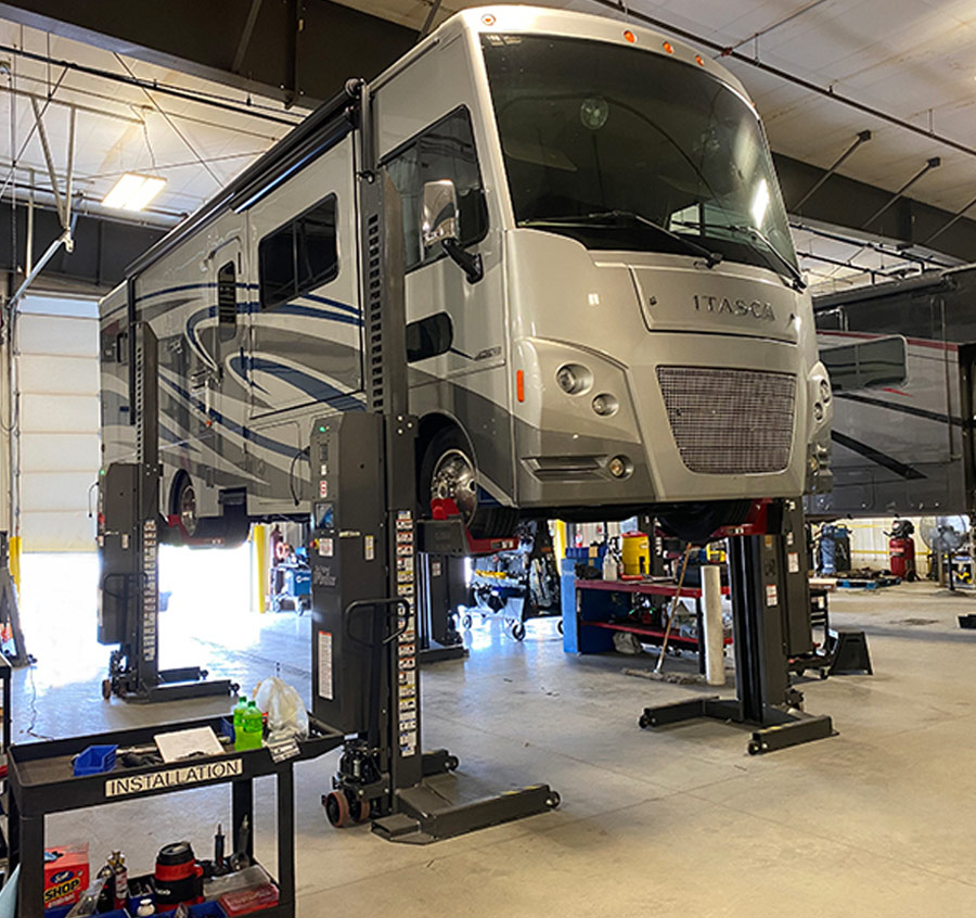 RV lifted in the shop