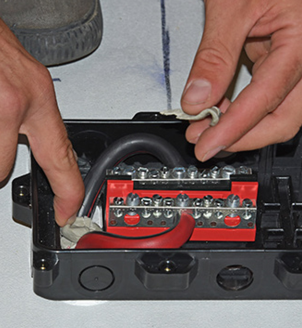 positive and negative cables are attached to their own bus terminals