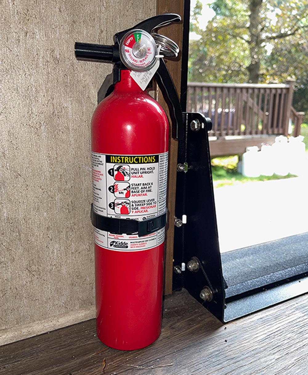 a fire extinguisher sits on the floor near a doorway