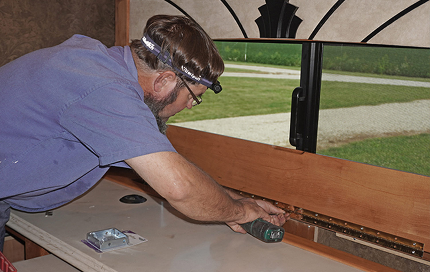 Borkholder begins work on the flip-up counter extension on the dinette that will open when the TV is lifted into position