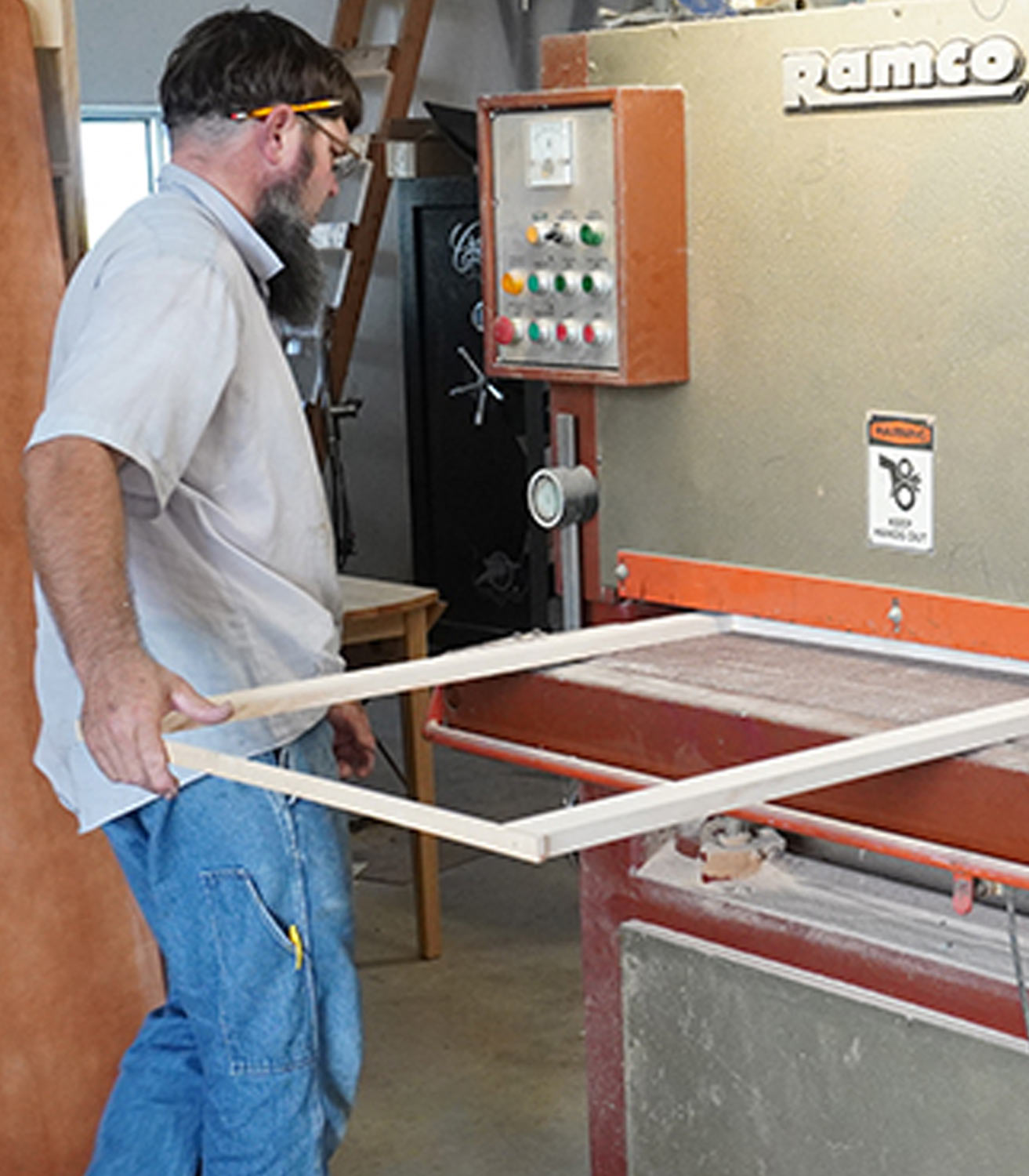 Borkholder runs a cabinet frame through a sanding machine