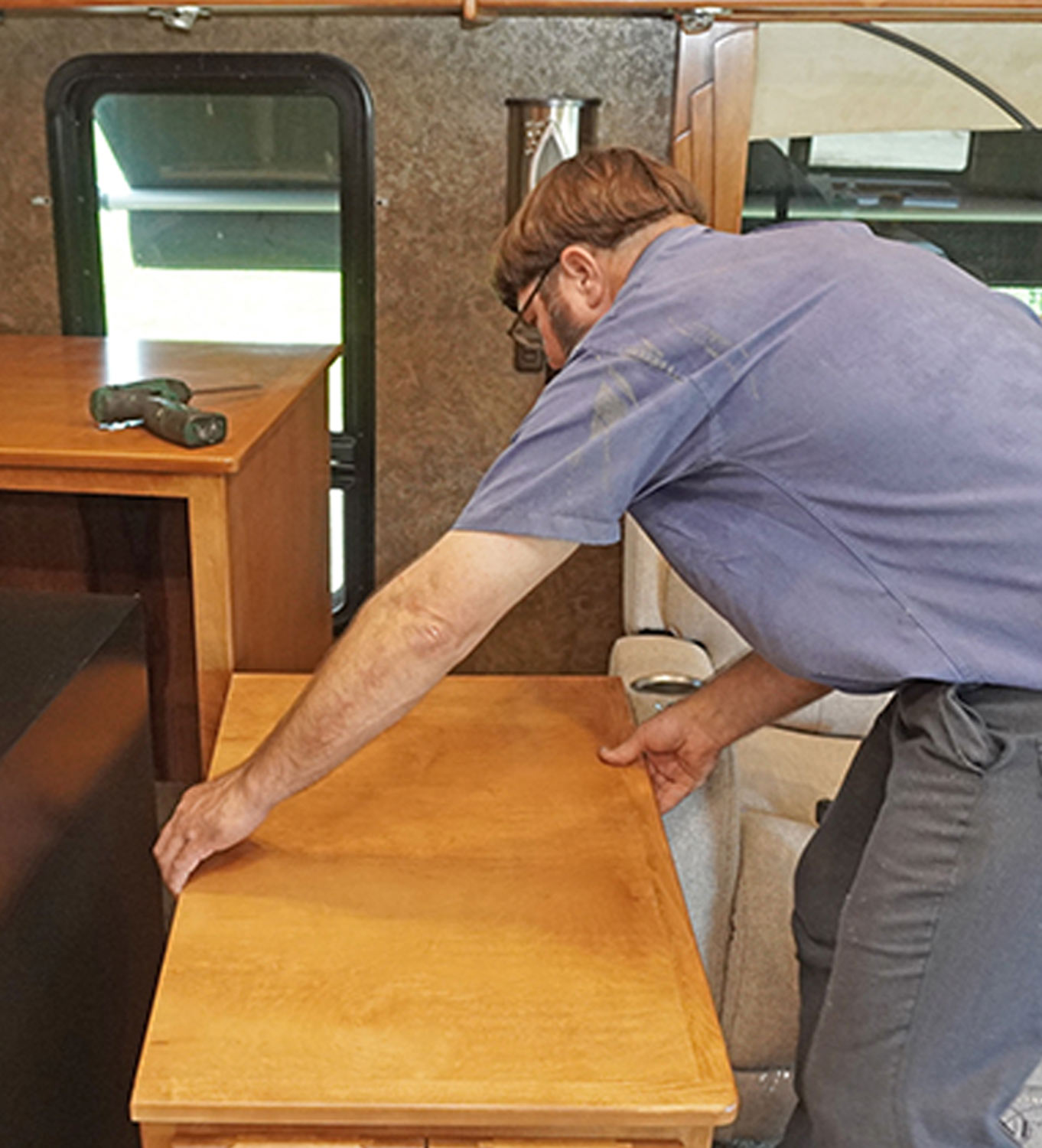 the rear end cabinet is fit into place between the wine cooler cabinet and theater seating