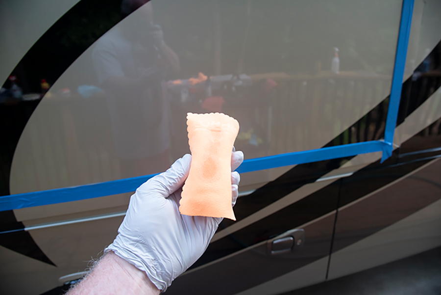 hand with glove getting wax process started with sponge