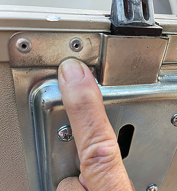 9: Adding the slam latch paddle locks to a second fifth wheel required drilling out rivets and setting new ones before the body of the lock could be fastened in place