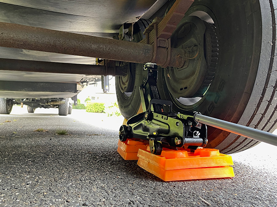 use some blocks and a trolley jack to lift the axle directly underneath the spring perch