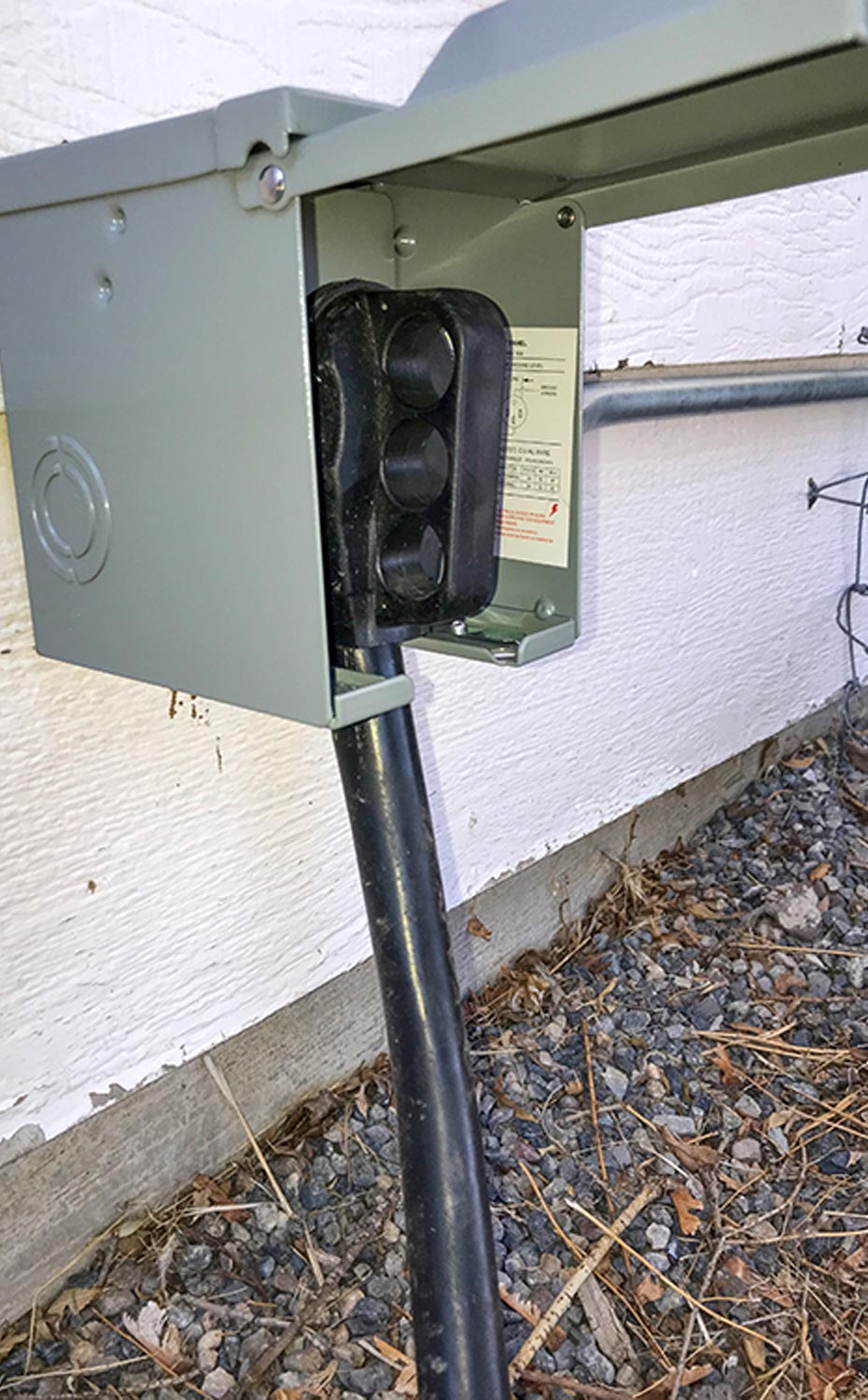 view of the home-based 50-amp RV shore power outlet installed on the side of a house