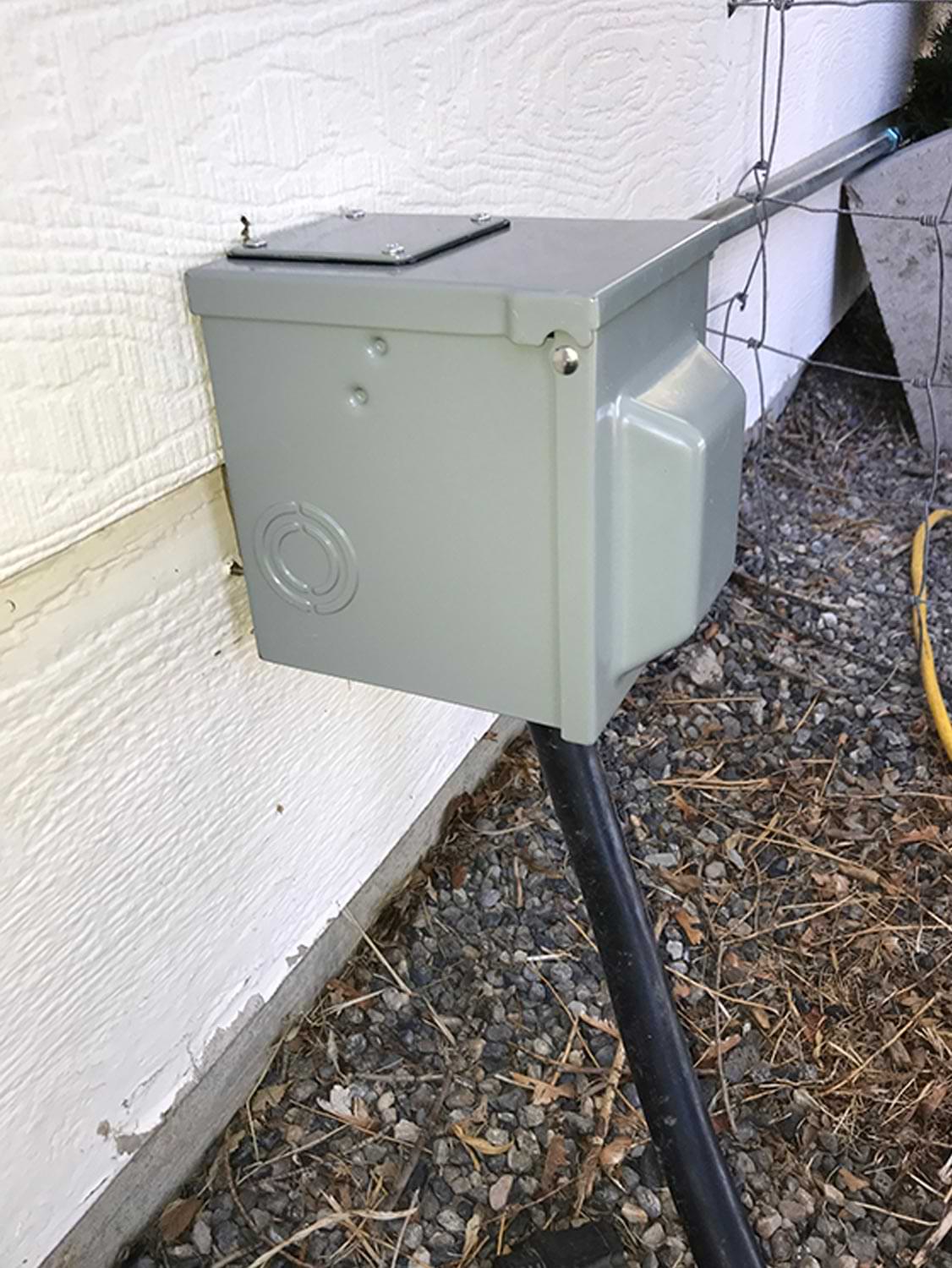 a 50-amp RV outlet box installed on the side of a home