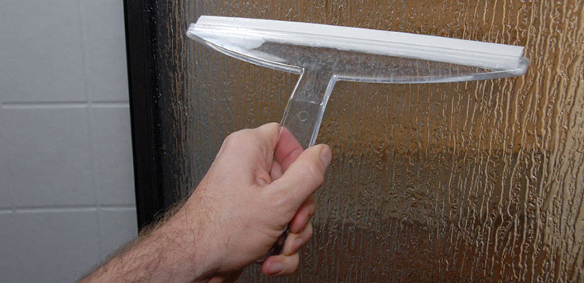 A shower squeegee like this one is invaluable at preventing hard water spots