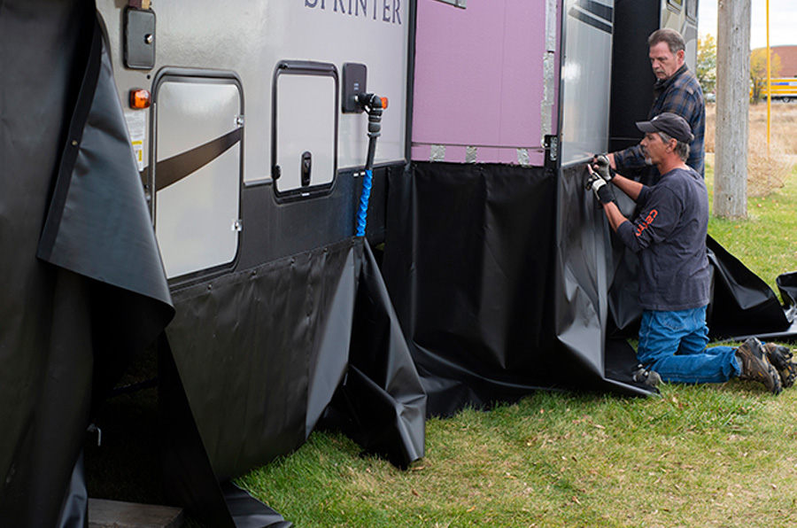 Jorgensen brings out the “pre-finish” vinyl panels and fits them around the fifth wheel