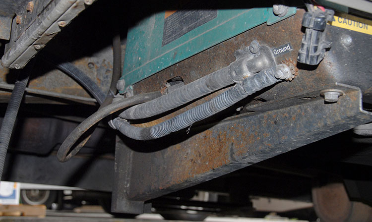 Moving underneath the motorhome, disconnect the ground cable followed by the rubber fuel line