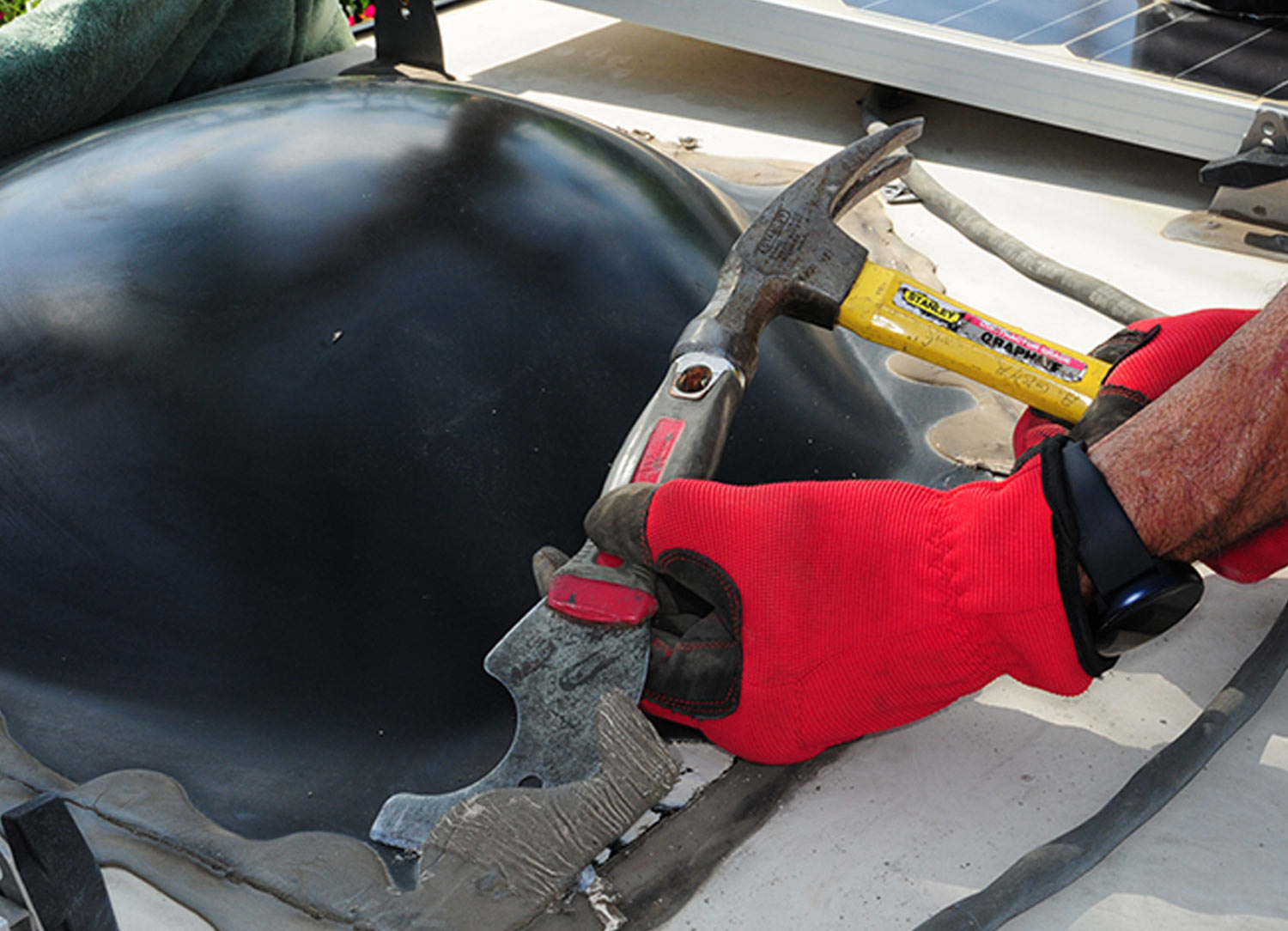 a hammer is used along with the putty knife to remove tougher areas of old sealant